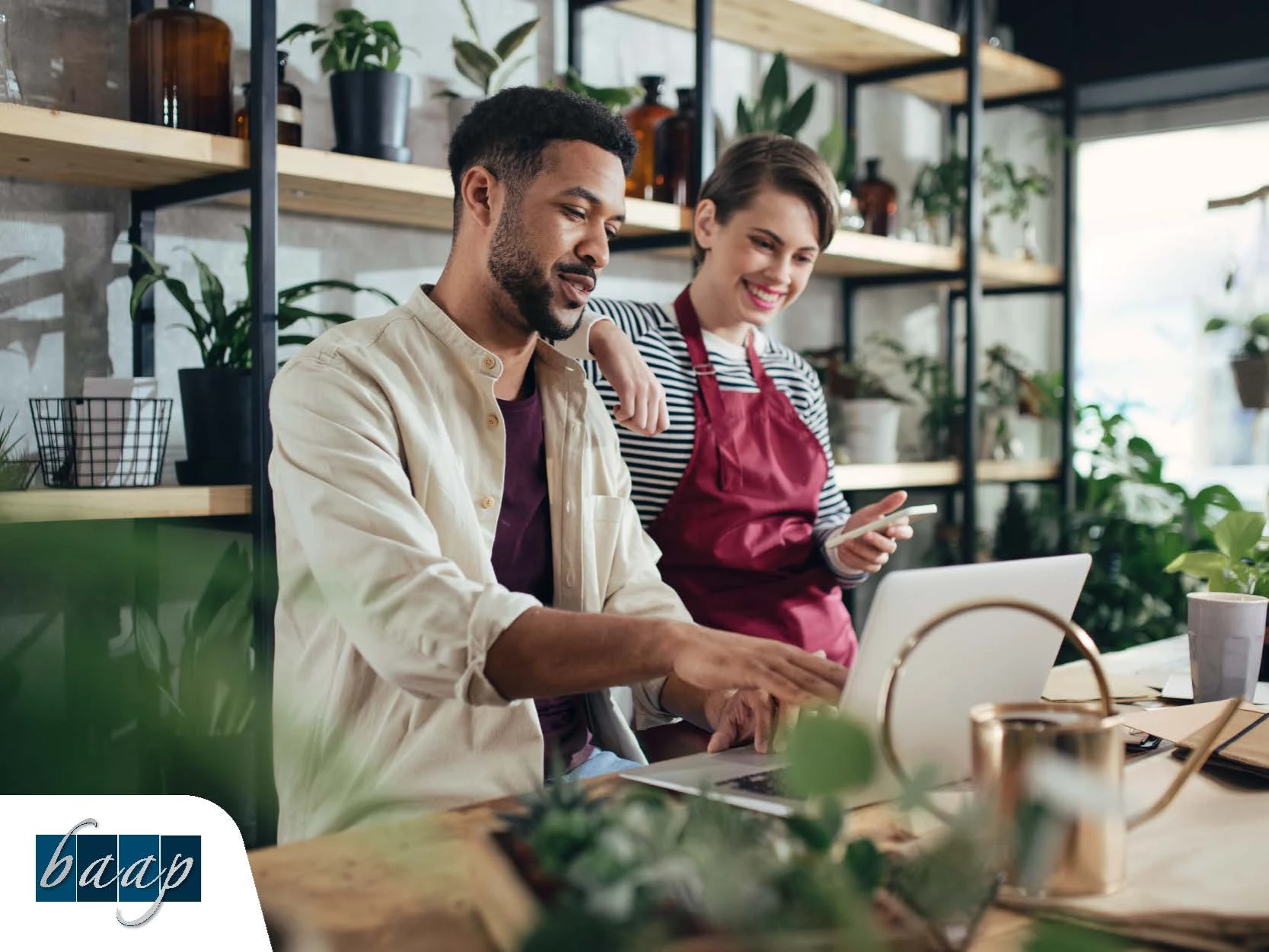 a man and woman looking at a computer